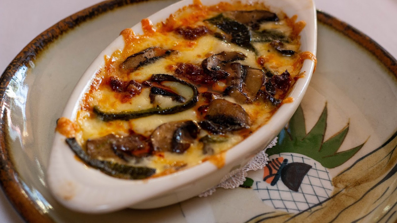 Baked chihuahua cheese with mushrooms and sausages